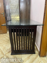 Wooden dining table with glass top